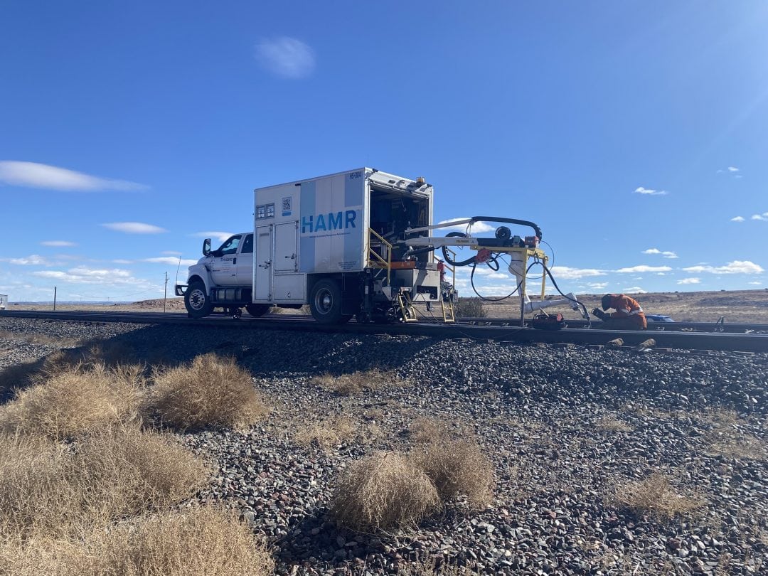 Holland railroad maintenance truck welding a rail switch.
